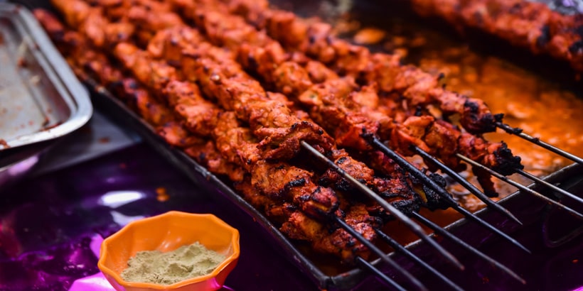 chicken seekh kababs being grilled heat